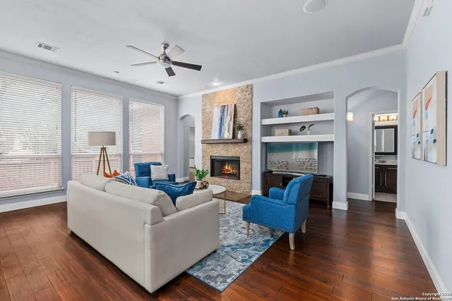 a living room with fireplace furniture and a wooden floor