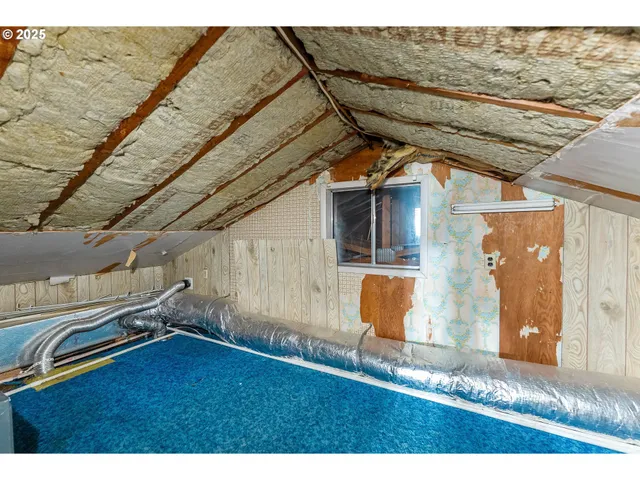 a view of empty room with wooden walls