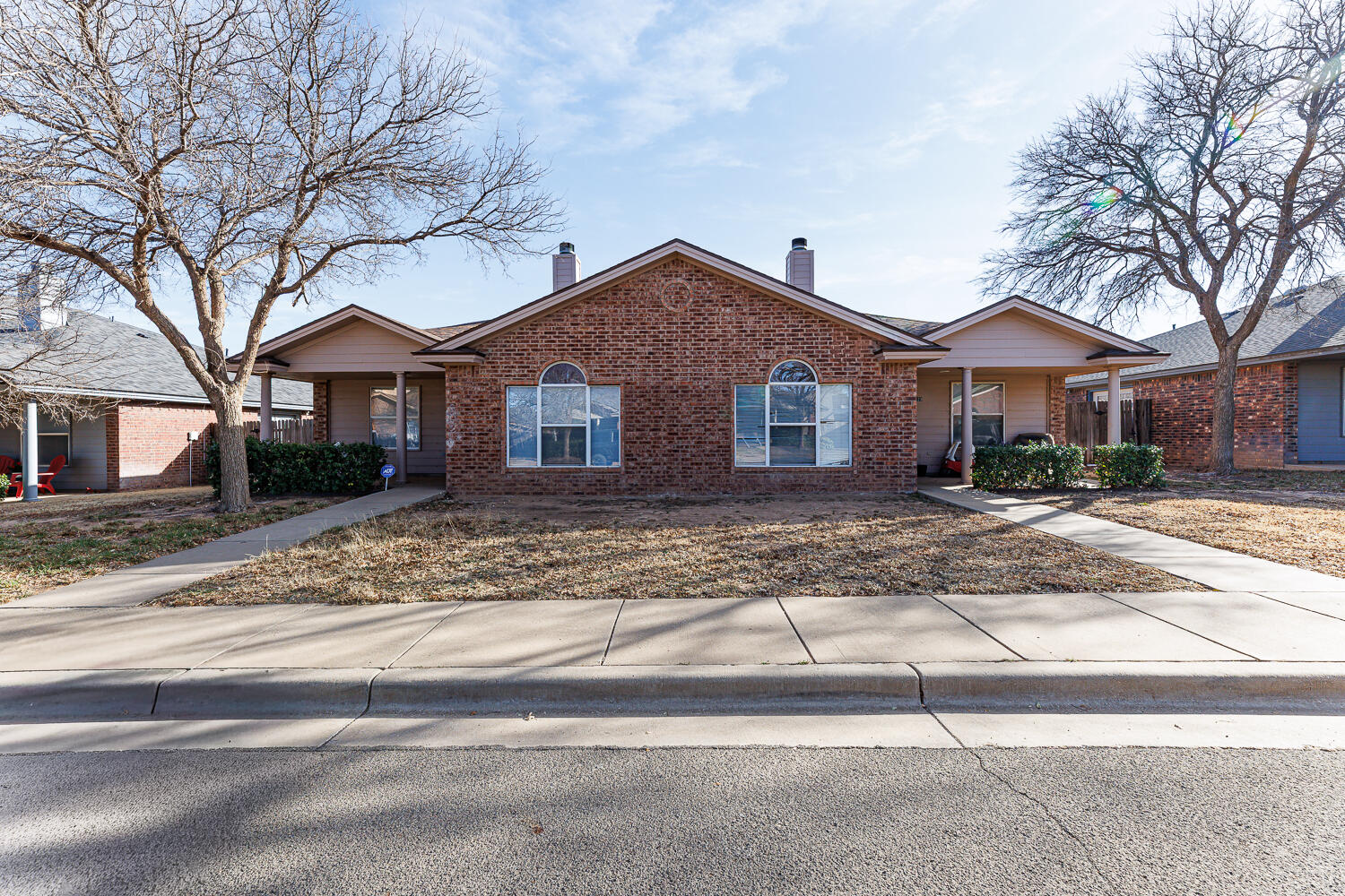 3423 97th Street Lubbock, TX 79423 - Photo 1 of 26 a front view of a house with a yard and garage