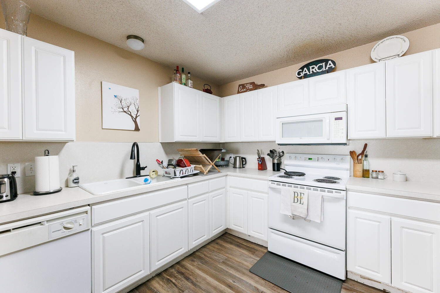 3423 97th Street Lubbock, TX 79423 - Photo 14 of 26 a kitchen with cabinets appliances cabinets and a sink