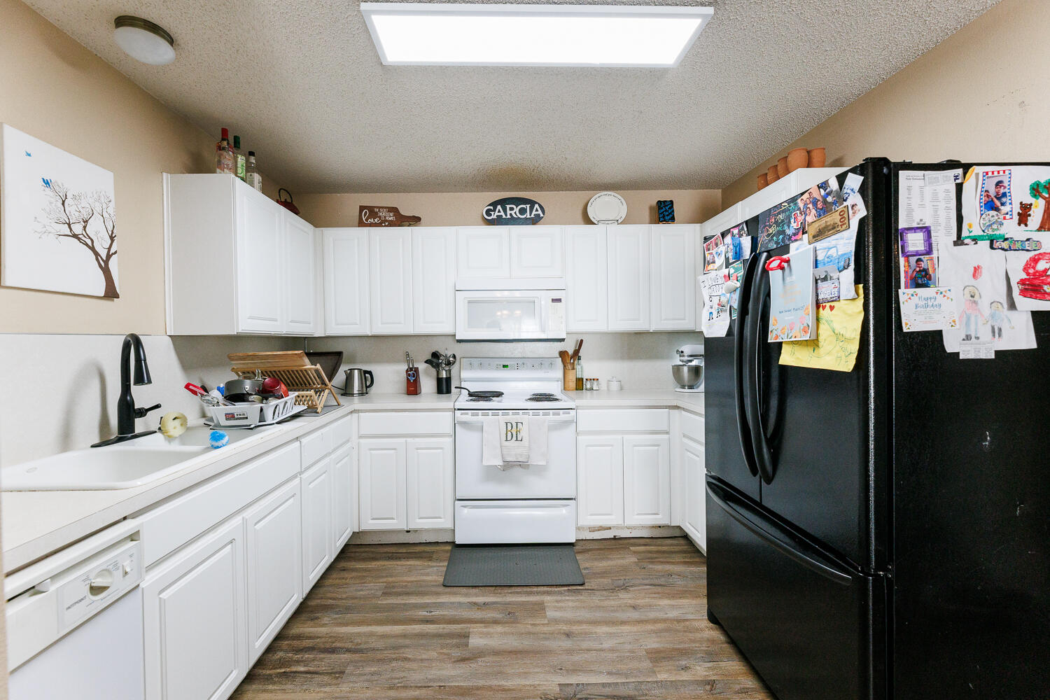 3423 97th Street Lubbock, TX 79423 - Photo 15 of 26 a kitchen with white cabinets and refrigerator