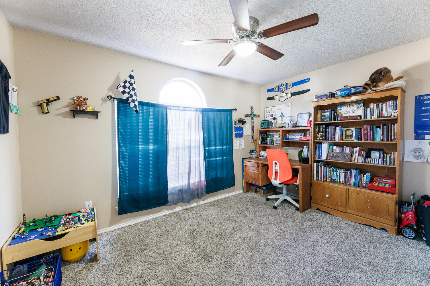 3423 97th Street Lubbock, TX 79423 - Photo 21 of 26 a bedroom with furniture and a book shelf