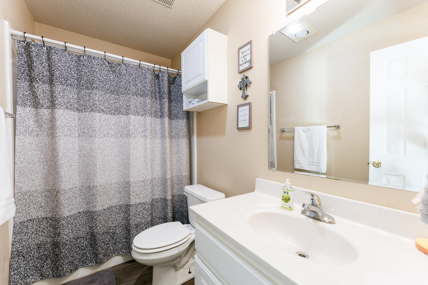 3423 97th Street Lubbock, TX 79423 - Photo 23 of 26 a bathroom with a sink toilet and shower