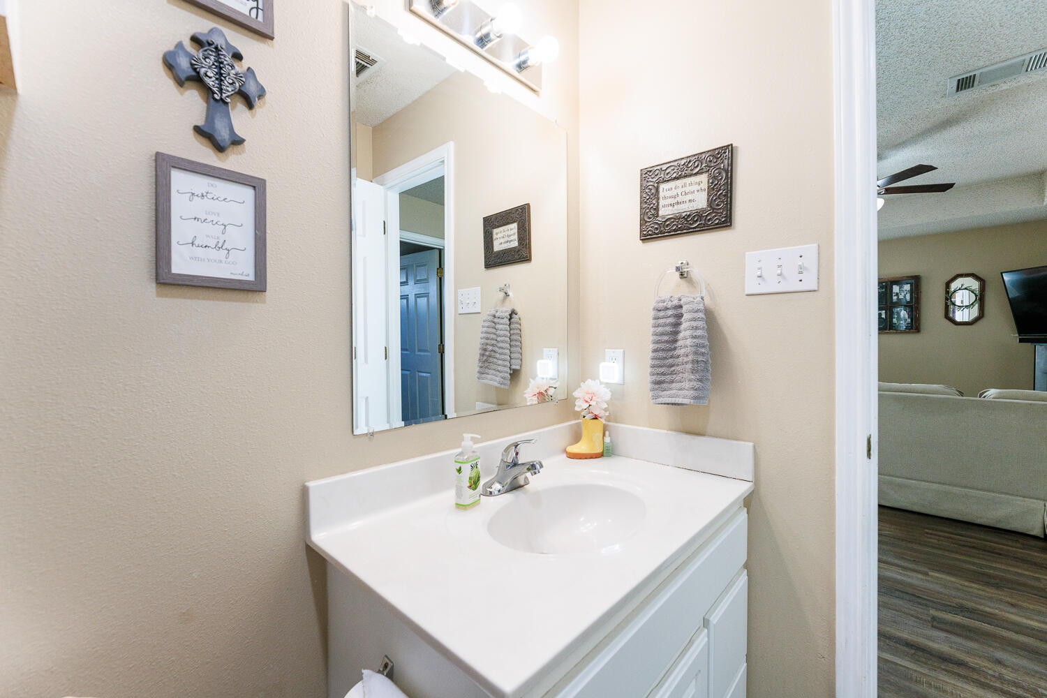 3423 97th Street Lubbock, TX 79423 - Photo 24 of 26 a bathroom with a sink and a mirror