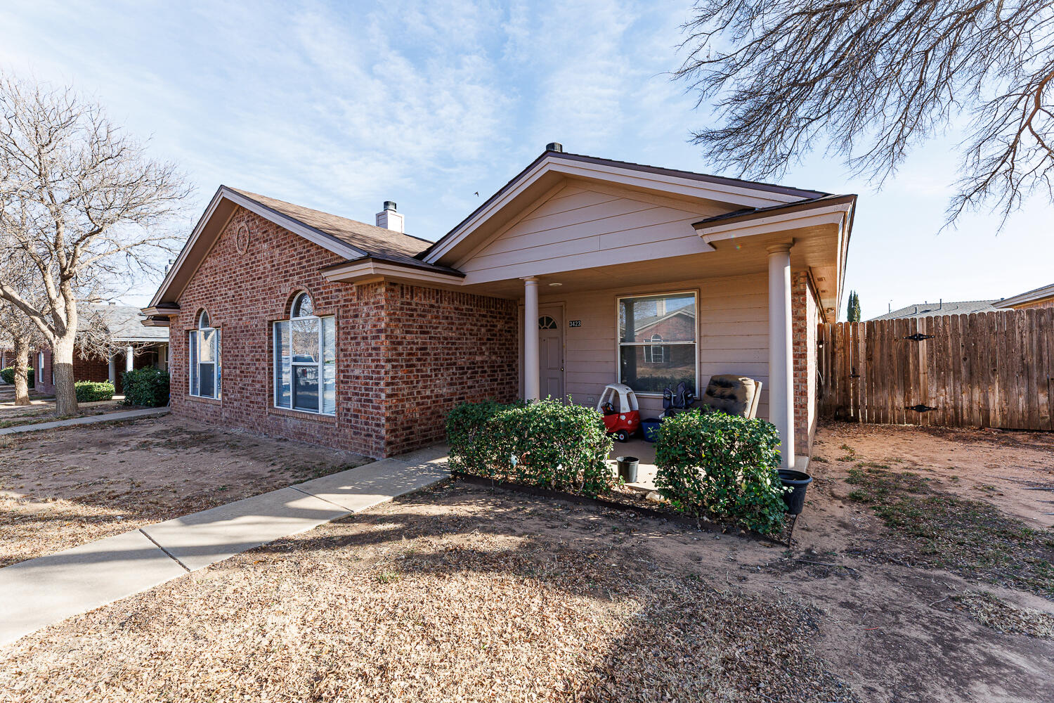 3423 97th Street Lubbock, TX 79423 - Photo 4 of 26 a front view of house with yard and trees around