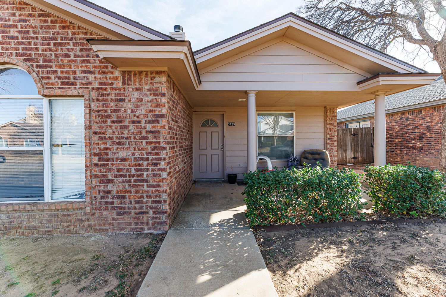 3423 97th Street Lubbock, TX 79423 - Photo 5 of 26 a front view of a house with garden