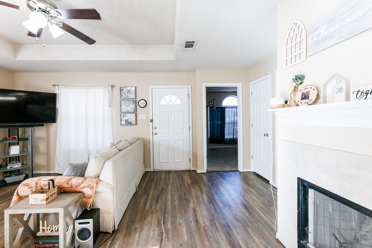 3423 97th Street Lubbock, TX 79423 - Photo 7 of 26 a hallway with furniture and wooden floor
