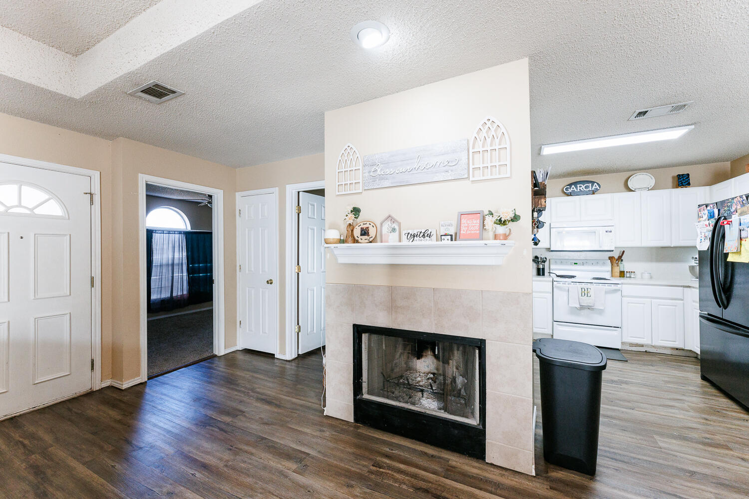 3423 97th Street Lubbock, TX 79423 - Photo 8 of 26 a living room with furniture and a fireplace
