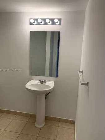 a bathroom with a sink and mirror