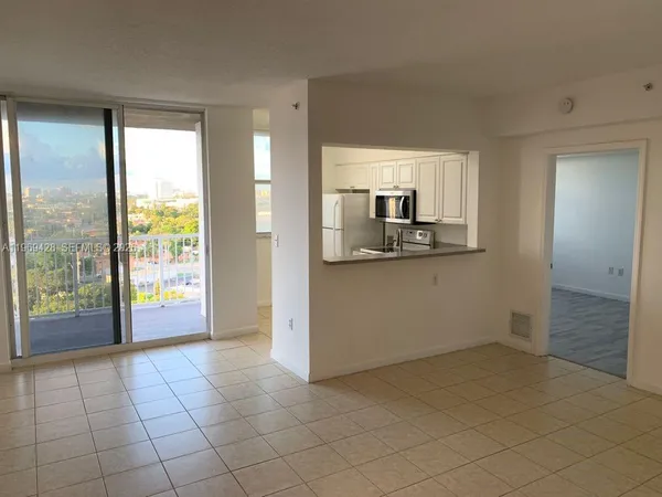 a view of a kitchen with a sink and natural light