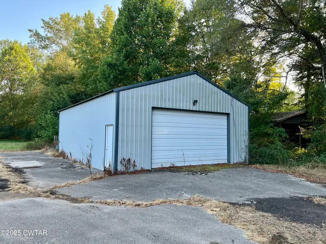 a view of a house with a yard and garage