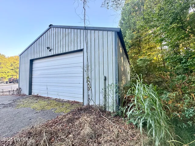 a view of house with backyard and garden