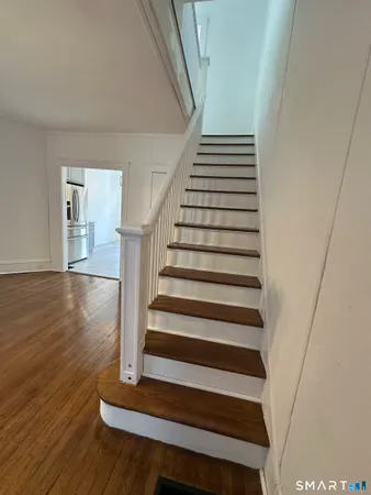a view of entryway and hall with wooden floor