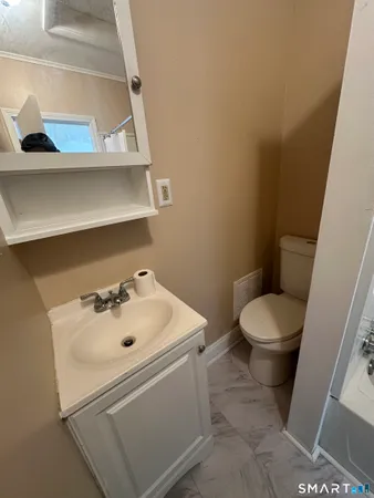 a bathroom with a sink toilet and vanity