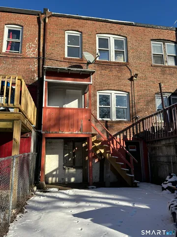 a view of a house with a car park side of road