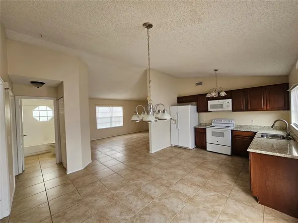 a kitchen with refrigerator and microwave