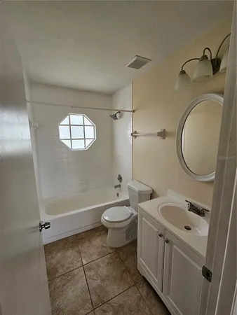 a bathroom with a bathtub sink mirror and toilet