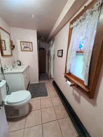 a bathroom with a toilet a sink and a shower