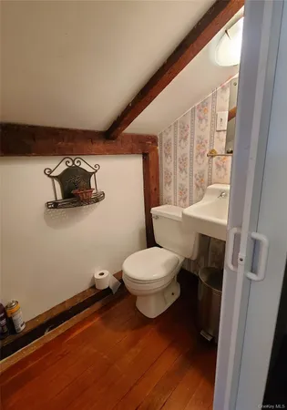a bathroom with a toilet a sink and a mirror