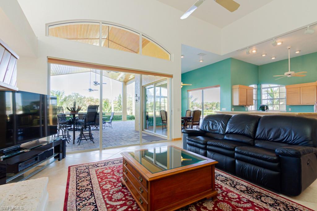 4401 Pond Apple Drive South Naples, FL 34119 - Photo 13 of 35 a living room with furniture a rug and a flat screen tv