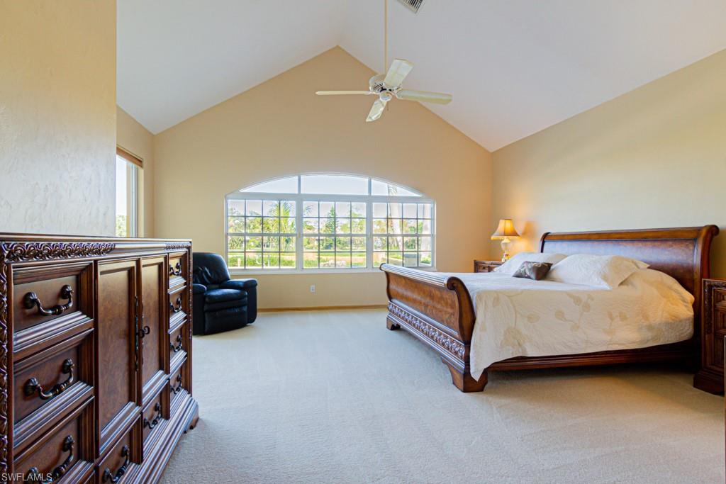 4401 Pond Apple Drive South Naples, FL 34119 - Photo 16 of 35 a spacious bedroom with a bed and a window