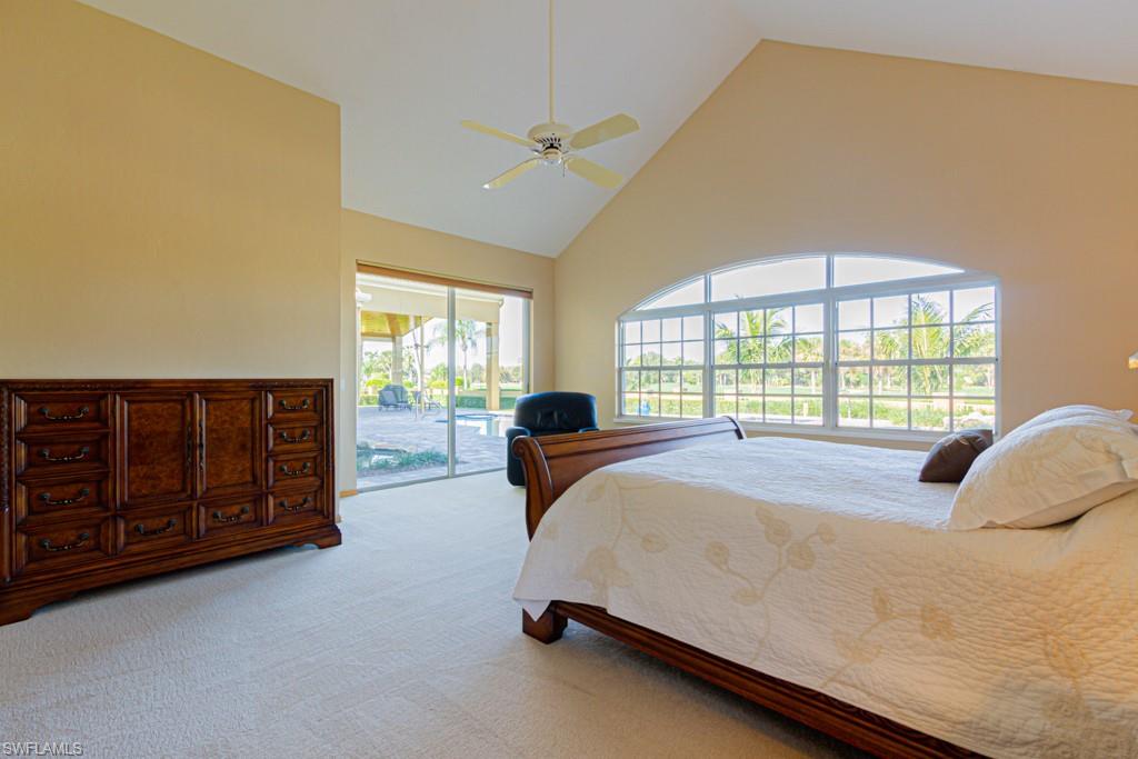 4401 Pond Apple Drive South Naples, FL 34119 - Photo 17 of 35 a bedroom with a bed a dresser with two large windows