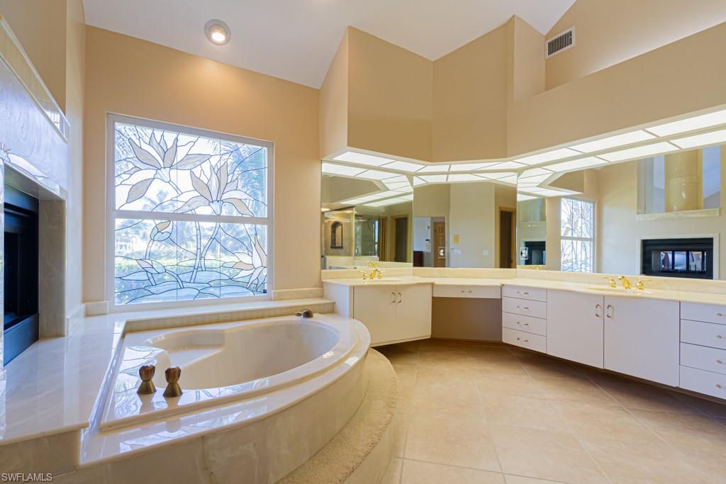 4401 Pond Apple Drive South Naples, FL 34119 - Photo 19 of 35 a large bathroom with a large tub and sink