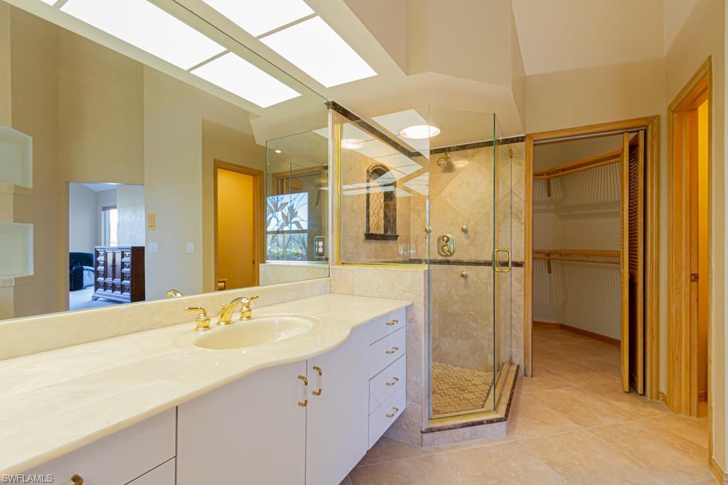 4401 Pond Apple Drive South Naples, FL 34119 - Photo 20 of 35 a bathroom with a double vanity sink and mirror