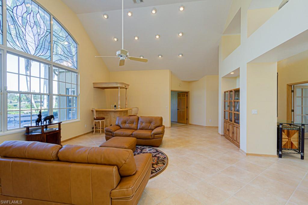 4401 Pond Apple Drive South Naples, FL 34119 - Photo 2 of 35 a living room with furniture and a flat screen tv