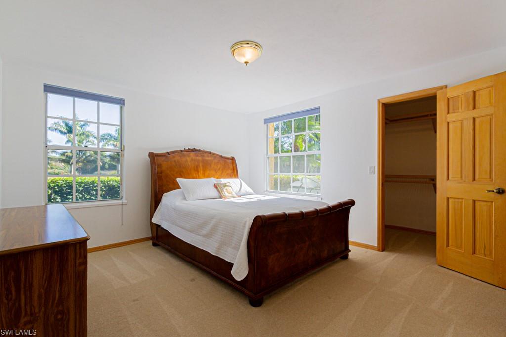 4401 Pond Apple Drive South Naples, FL 34119 - Photo 21 of 35 a bedroom with a bed and window