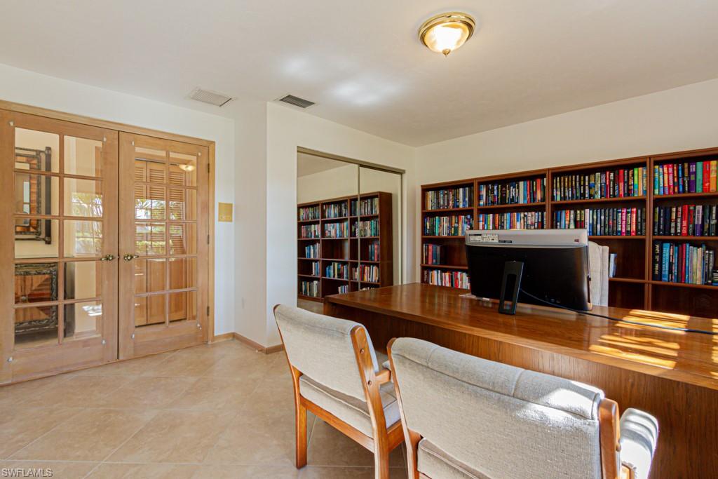 4401 Pond Apple Drive South Naples, FL 34119 - Photo 24 of 35 a living room with furniture and a book shelf