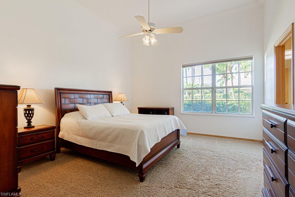 4401 Pond Apple Drive South Naples, FL 34119 - Photo 25 of 35 a bedroom with a bed and a window