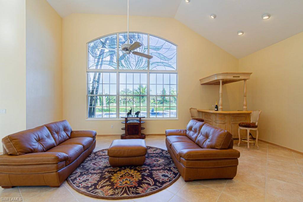 4401 Pond Apple Drive South Naples, FL 34119 - Photo 3 of 35 a living room with furniture and a large window