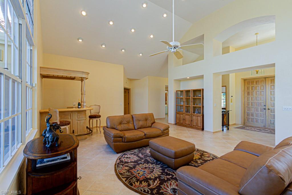 4401 Pond Apple Drive South Naples, FL 34119 - Photo 4 of 35 a living room with furniture ceiling fan and a rug