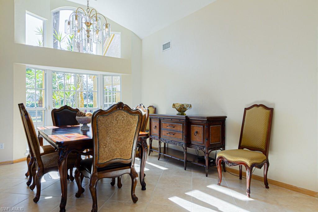 4401 Pond Apple Drive South Naples, FL 34119 - Photo 7 of 35 a view of a dining room with furniture and a window