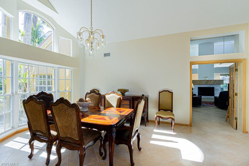 4401 Pond Apple Drive South Naples, FL 34119 - Photo 8 of 35 a view of a dining room with furniture window and outside view