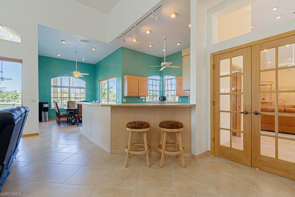 4401 Pond Apple Drive South Naples, FL 34119 - Photo 10 of 35 a dining hall with stainless steel appliances a dining table and chairs