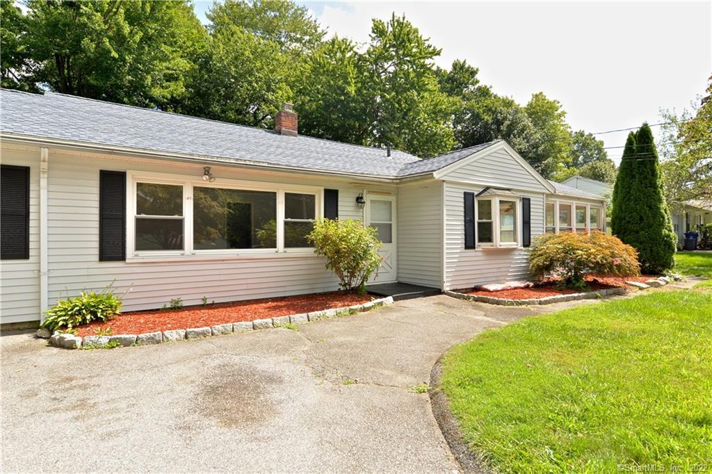 9 Barjune Road Norwalk, CT 06851 - Photo 1 of 1 a front view of a house with a yard and garage