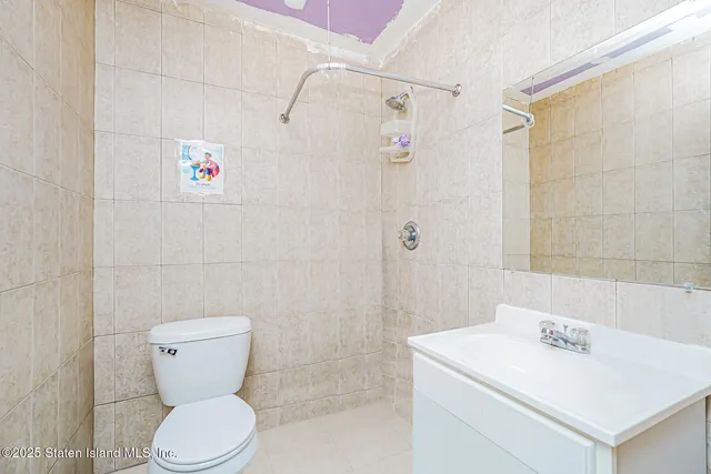 a bathroom with a sink a shower and a mirror