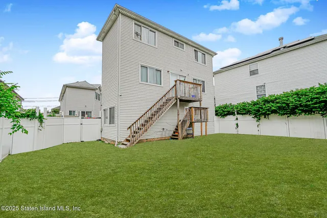a view of a house with a yard and deck