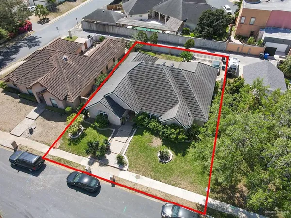 an aerial view of a house with garden space and street view