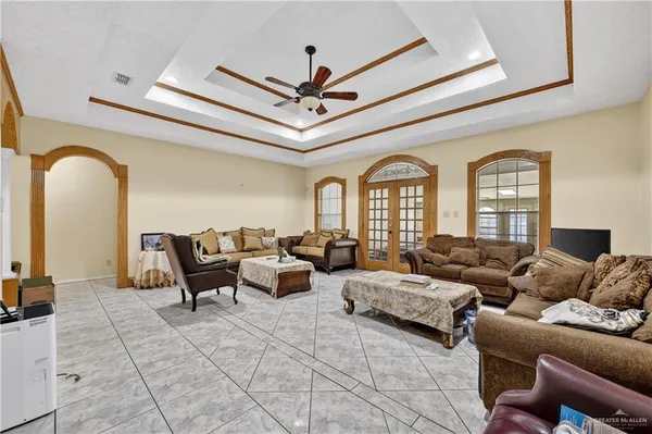 a living room with furniture and a chandelier