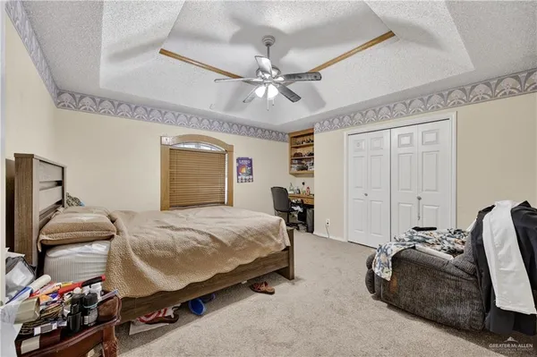 a bedroom with bed and a chandelier
