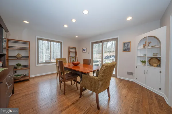 a living room with furniture a flat screen tv and a floor to ceiling window