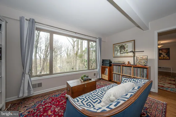 a view of a workspace with furniture and a window