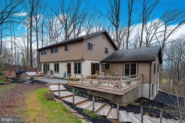 a view of backyard with swimming pool and outdoor seating