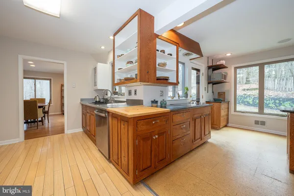 a large kitchen with stainless steel appliances granite countertop a large counter top and a stove