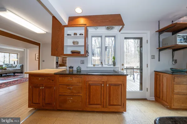 a spacious bathroom with a granite countertop sink and a mirror