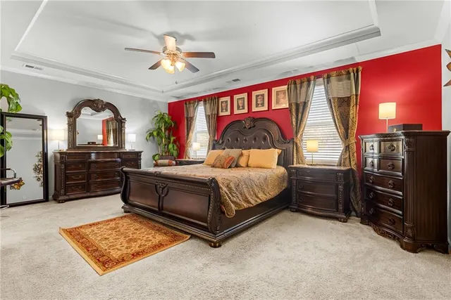 a bedroom with a bed and a painting on the wall