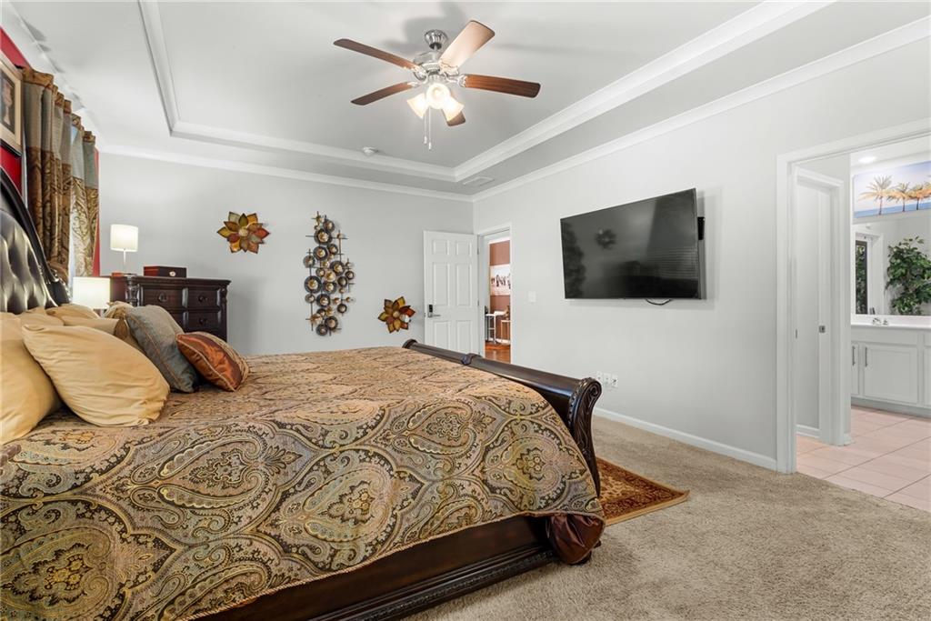 1476 Harlequin Way Stockbridge, GA 30281 - Photo 22 of 57 a bedroom with a bed and a flat screen tv